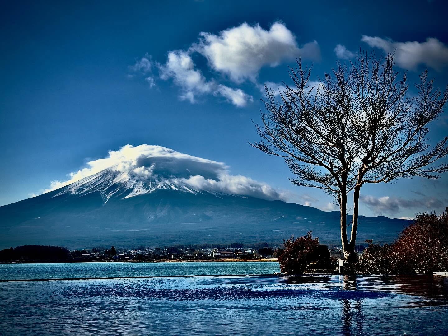 Fuji mountain rising above a misty landscape